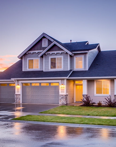 Modern suburban home with illuminated windows, showcasing a welcoming exterior, relevant to 24/7 house lockout services in Houston.