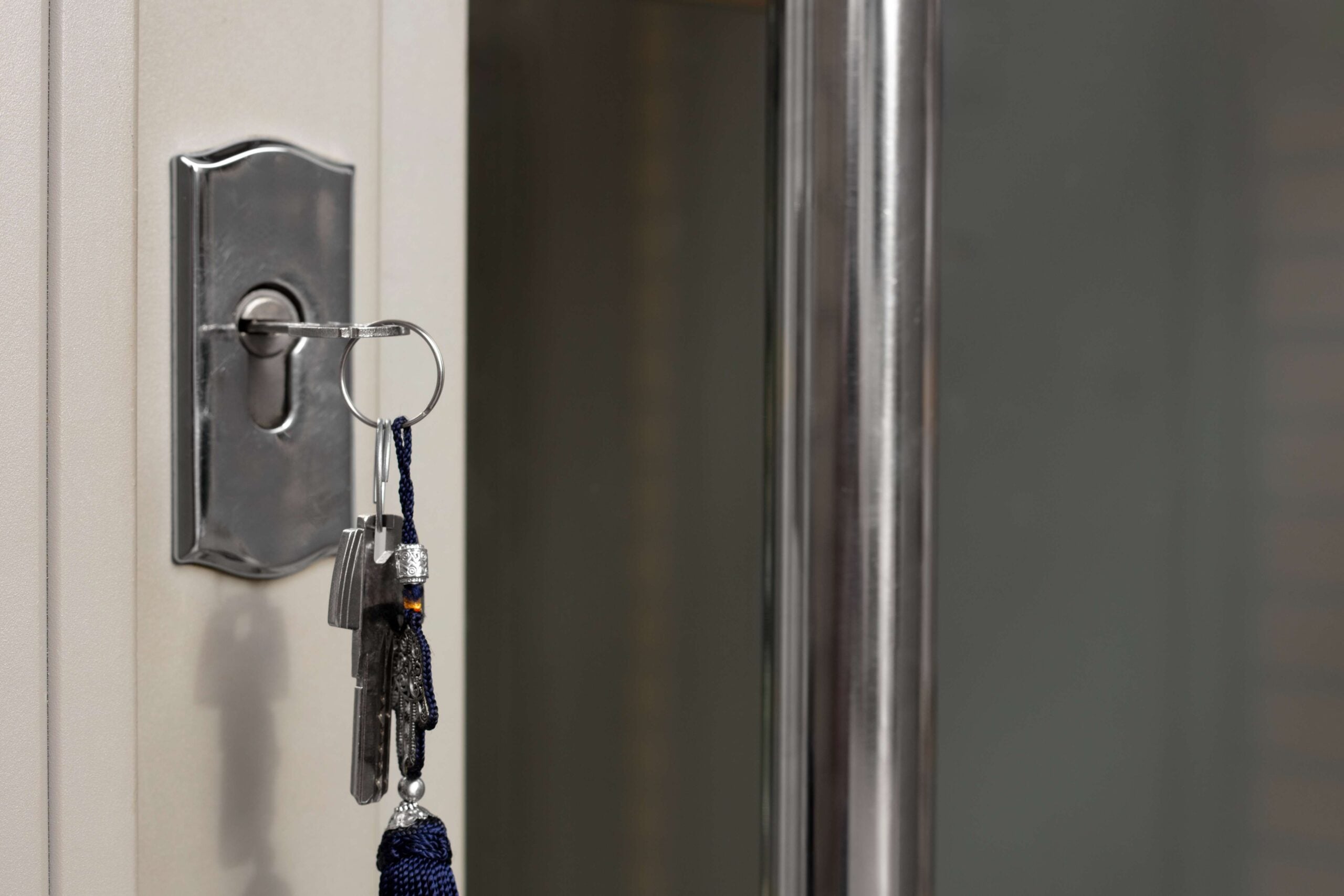Key in a door lock with attached keychain, symbolizing security and locksmith services for residential and commercial properties.
