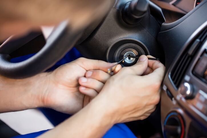 Automotive locksmith repairing ignition lock with tools inside a vehicle, illustrating Houston Secure Locksmith's car key extraction and ignition repair services.