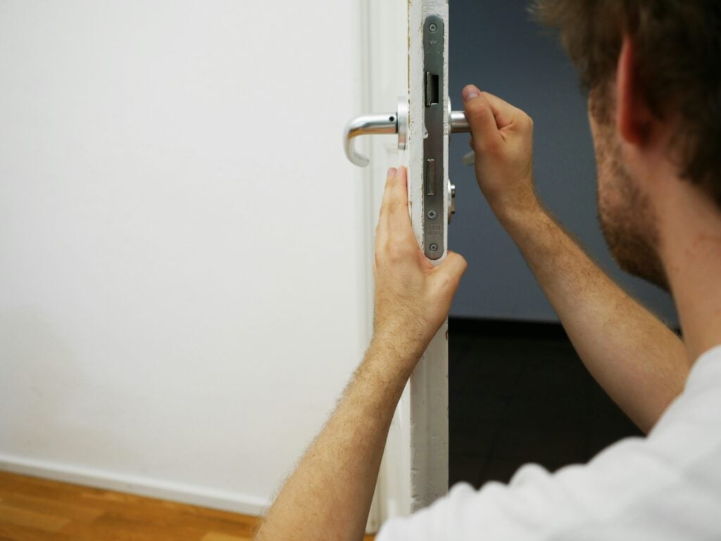 Locksmith unlocking a door for emergency lockout service in Houston.